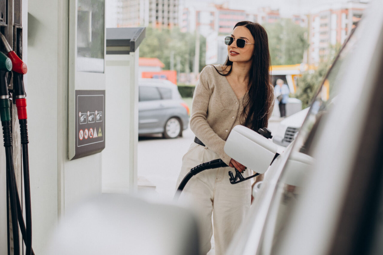 Woman charging car gas station